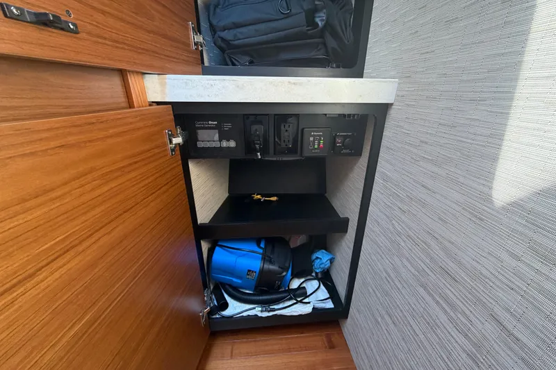 Slide: The Image of 2016 Tiara Yachts C39 Coupe interior cabinet with storage and electrical panel. - 28