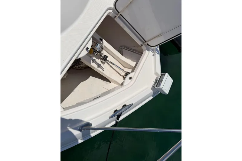Slide: The Image of 2016 Tiara Yachts C39 Coupe anchor compartment with open hatch, docked on calm water. - 30