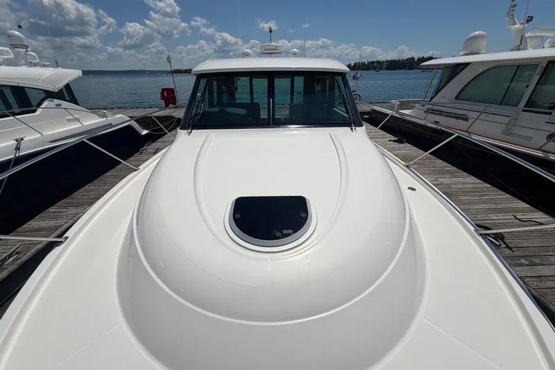 Slide: The Image of 2016 Tiara Yachts C39 Coupe docked, showcasing sleek design and spacious deck. - 32