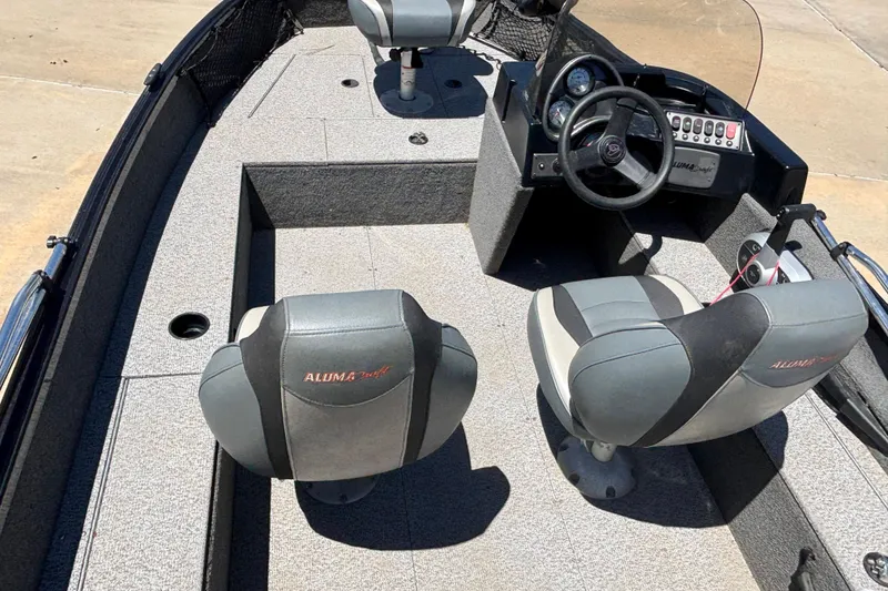 Slide: The Image of 2021 Alumacraft Classic 165 boat interior with steering console and seating. - 3