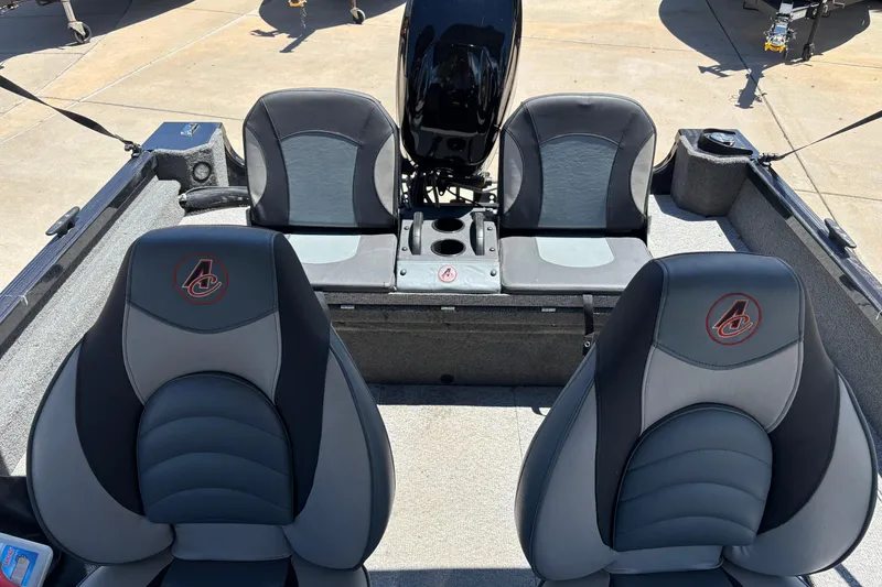 Slide: The Image of 2021 Alumacraft Classic 165 boat interior with four cushioned seats and motor. - 6