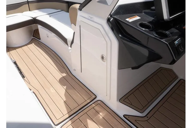 Slide: The Image of 2023 Yamaha Boats 275SDX interior with sleek seating and wood-style flooring. - 10