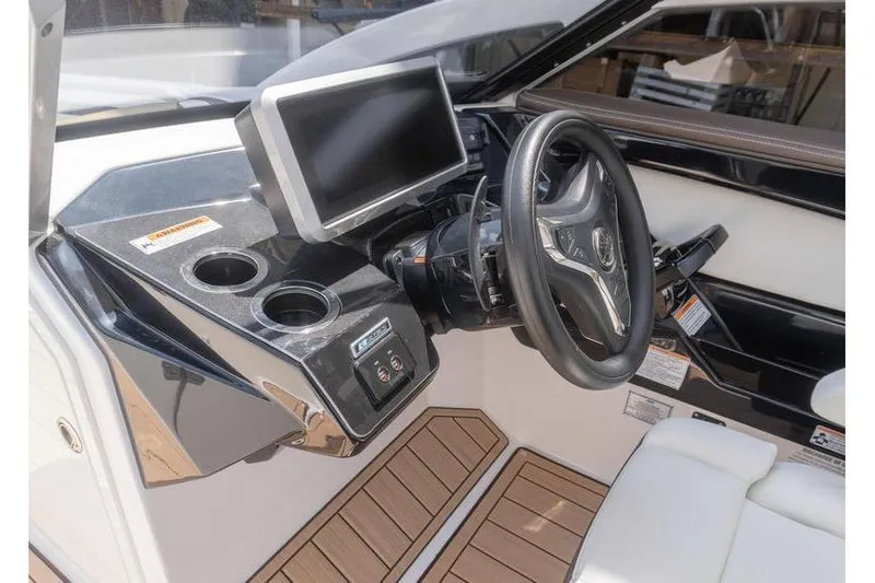 Slide: The Image of 2023 Yamaha Boats 275SDX helm with steering wheel, touchscreen, and cup holders. - 14