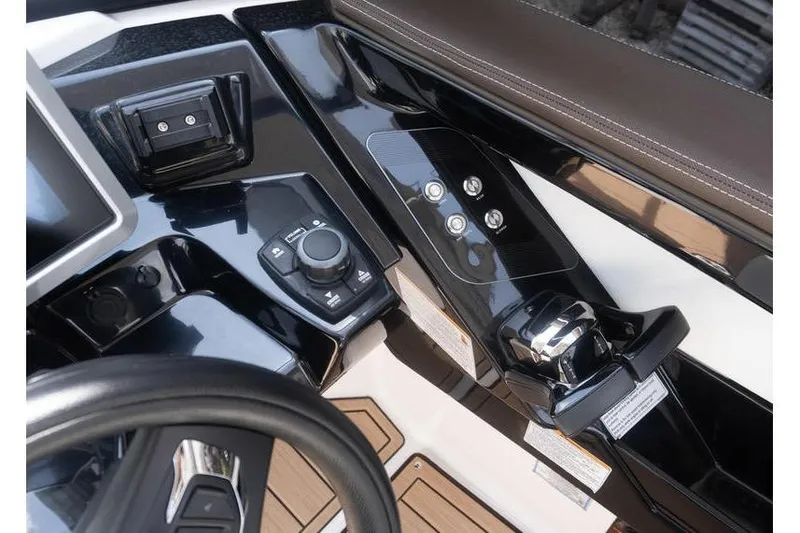 Slide: The Image of Control panel of 2023 Yamaha Boats 275SDX, featuring sleek black design and modern controls. - 16