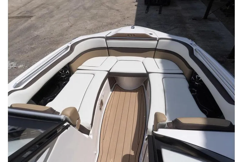 Slide: The Image of 2023 Yamaha Boats 275SDX interior with luxurious seating and teak flooring. - 17