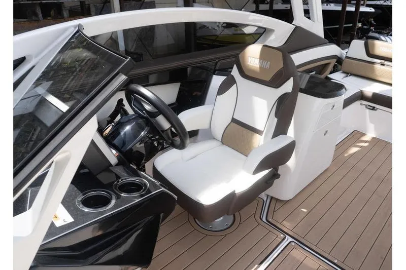 Slide: The Image of 2023 Yamaha Boats 275SDX cockpit with luxurious seating and modern dashboard design. - 23