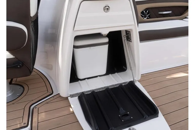Slide: The Image of 2023 Yamaha Boats 275SDX interior storage compartment with cooler on teak deck. - 26