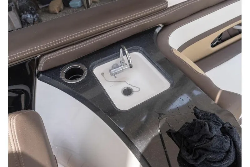 Slide: The Image of 2023 Yamaha Boats 275SDX interior sink and cup holder detail. - 27