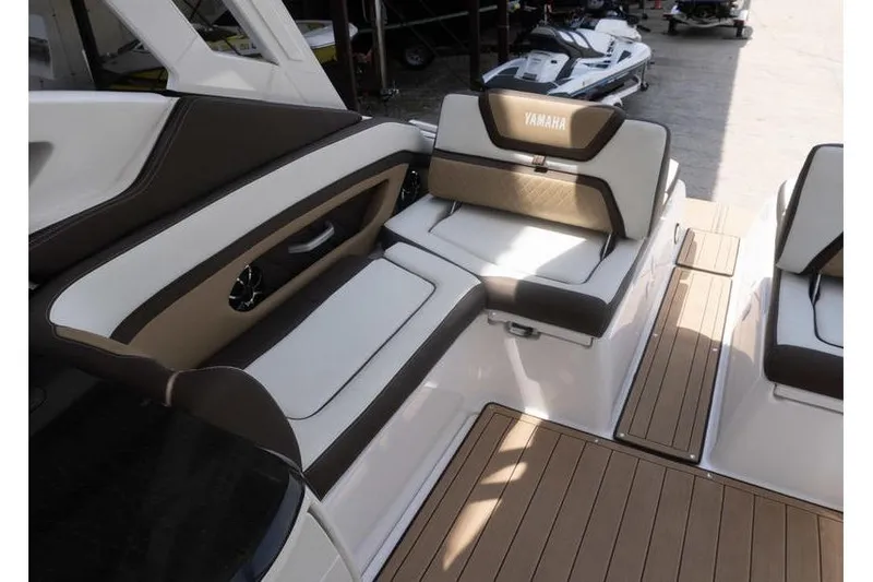 Slide: The Image of 2023 Yamaha Boats 275SDX interior with luxurious seating and teak flooring. - 28