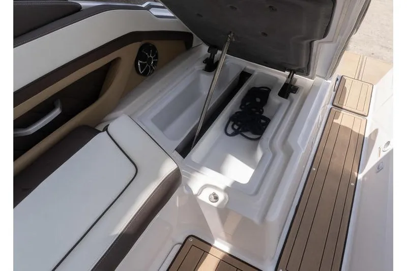 Slide: The Image of 2023 Yamaha Boats 275SDX storage compartment with open lid and visible ropes. - 29