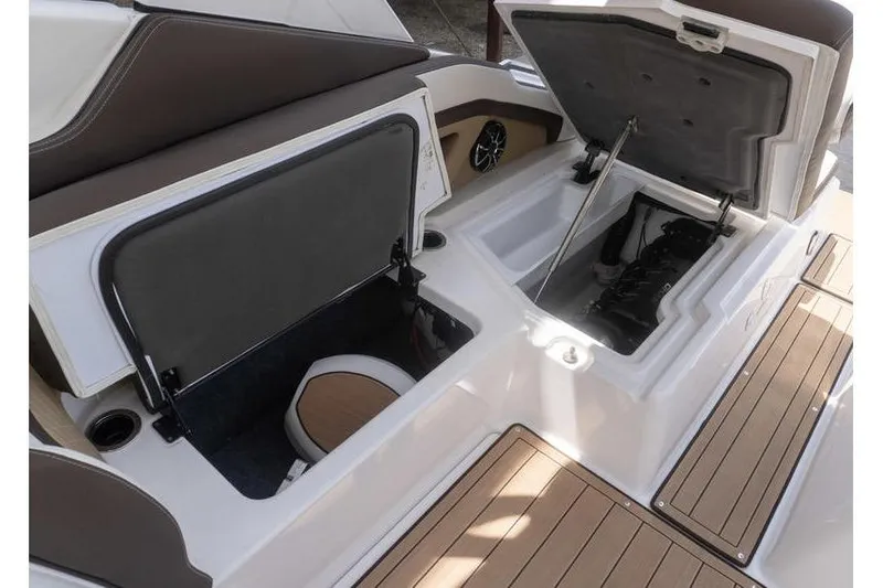 Slide: The Image of 2023 Yamaha Boats 275SDX interior storage compartments and engine bay, featuring sleek design. - 30