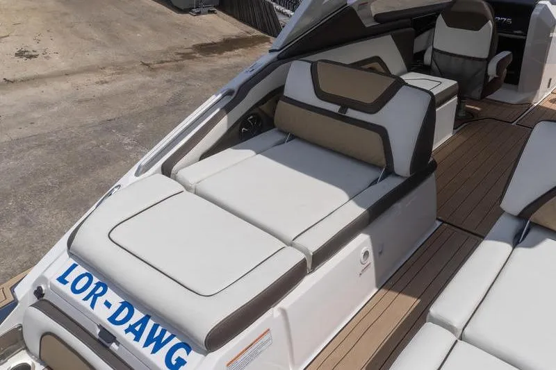 Slide: The Image of 2023 Yamaha Boats 275SDX interior with cushioned seating and teak flooring. - 4