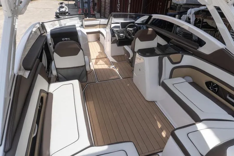 Slide: The Image of 2023 Yamaha Boats 275SDX interior with luxurious seating and sleek design. - 6