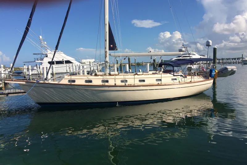 The Image of Sailboat docked at marina, Island Packet 45, 1999 model, under clear blue sky. - 1