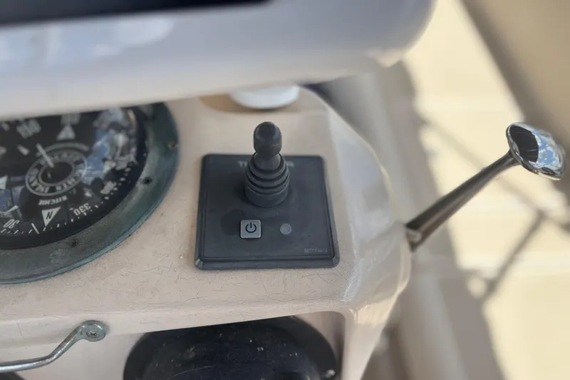 Slide: The Image of Control panel of a 1999 Island Packet 45 sailboat with compass and joystick. - 12