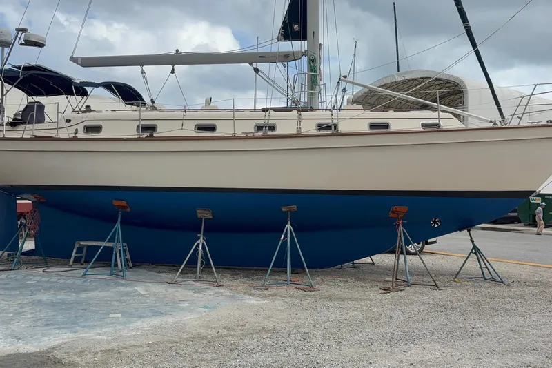Slide: The Image of 1999 Island Packet 45 sailboat on stands, showcasing hull and deck design. - 2