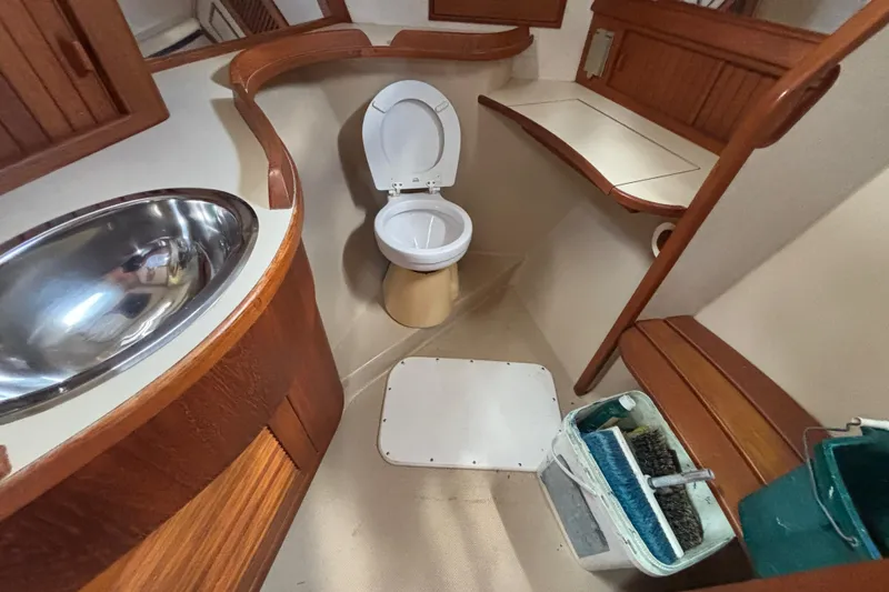 Slide: The Image of Bathroom interior of a 1999 Island Packet 45 yacht with wooden accents and stainless steel sink. - 20