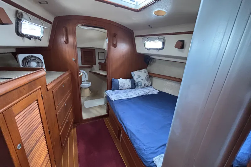 Slide: The Image of Cabin interior of 1999 Island Packet 45 sailboat with bed and bathroom. - 22