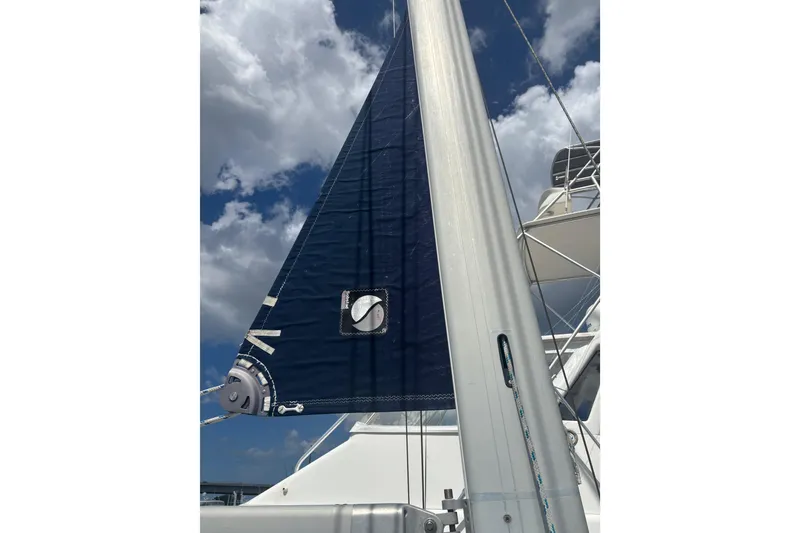 Slide: The Image of Sail of a 1999 Island Packet 45 yacht against a cloudy sky. - 25