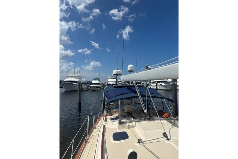 Slide: The Image of Sailboat docked at marina under blue sky, Island Packet 45, 1999 model. - 26