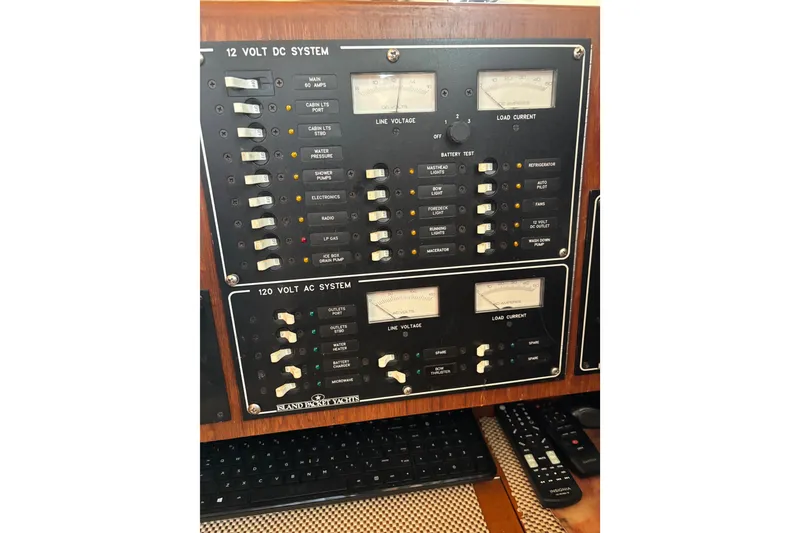 Slide: The Image of Electrical control panel on a 1999 Island Packet 45 yacht, featuring 12V and 120V systems. - 3