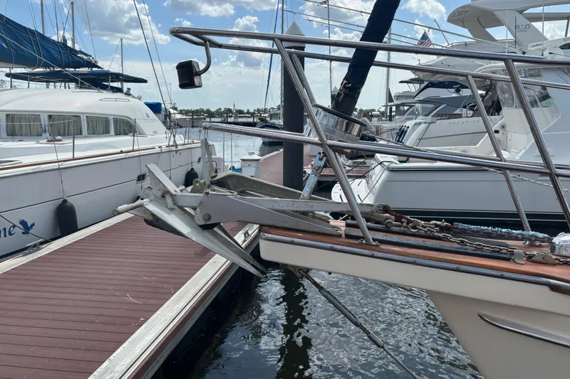 Slide: The Image of Bow of 1999 Island Packet 45 yacht docked at marina with anchor visible. - 31