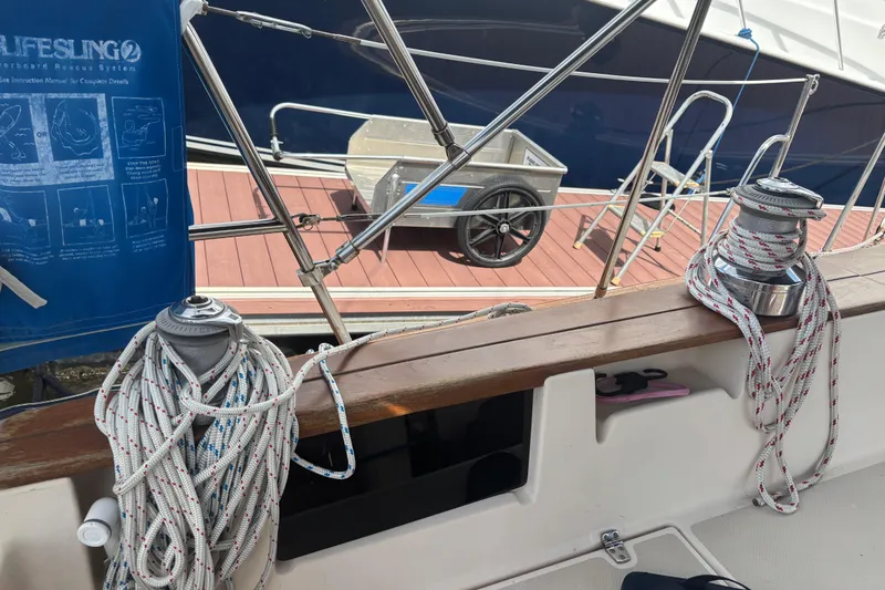 Slide: The Image of Sailboat deck of 1999 Island Packet 45 with ropes and winches, dockside view. - 34