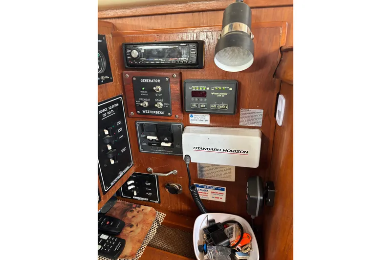 Slide: The Image of Control panel of a 1999 Island Packet 45 sailboat with navigation and generator controls. - 4