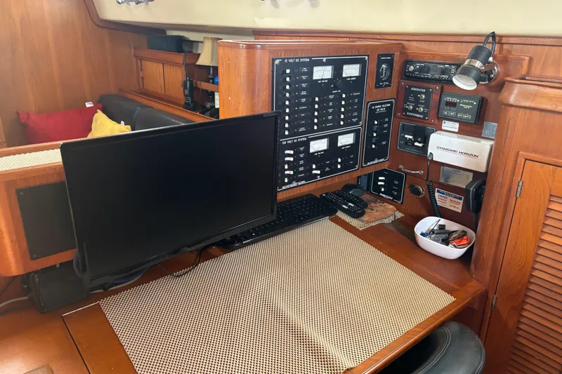 Slide: The Image of Navigation station on a 1999 Island Packet 45 yacht with control panels and monitor. - 5