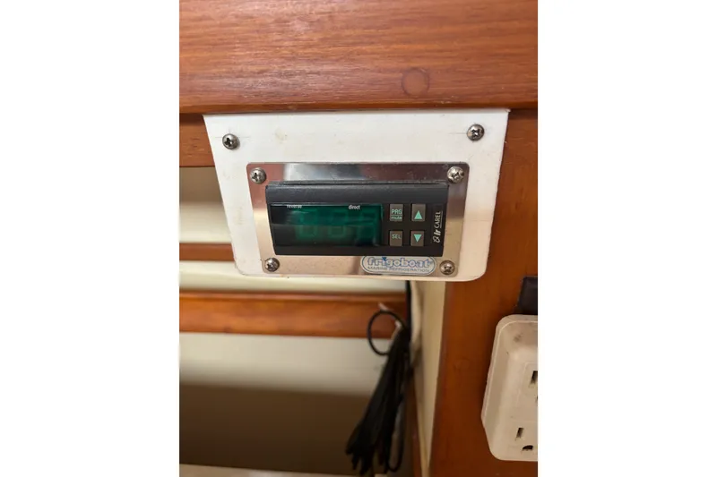 Slide: The Image of Control panel of a 1999 Island Packet 45 sailboat with Frigoboat refrigeration. - 8