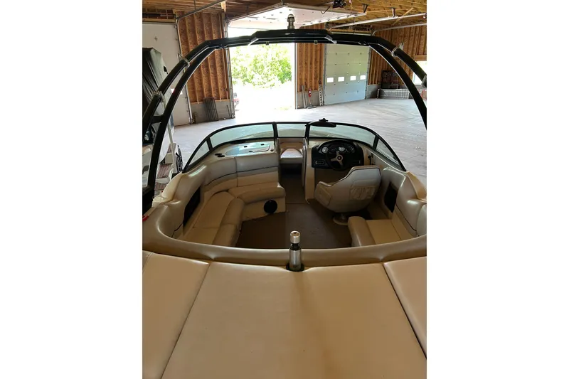 Slide: The Image of Interior view of a 2001 Gekko G3 boat with beige seating and steering console. - 2
