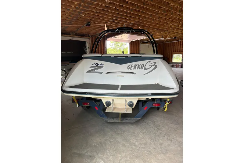 Slide: The Image of 2001 Gekko G3 boat in garage, rear view showing "Flyin Z" branding. - 3