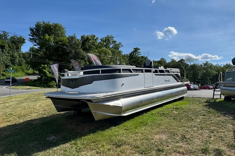 The Image of 2026 Tahoe Pontoon Sport 85 Quad Lounger 23 on grassy display under clear blue sky. - 0