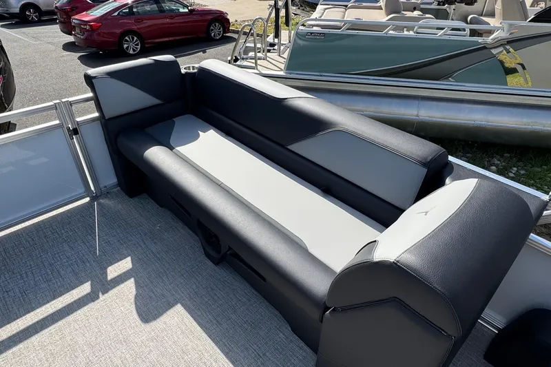 Slide: The Image of 2026 Tahoe Pontoon Sport 85 Quad Lounger 23 interior seating, featuring sleek black and gray upholstery. - 6
