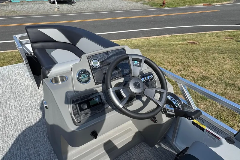 Slide: The Image of 2026 Tahoe Pontoon Sport 85 Quad Lounger 23 steering console with modern controls and seating. - 8