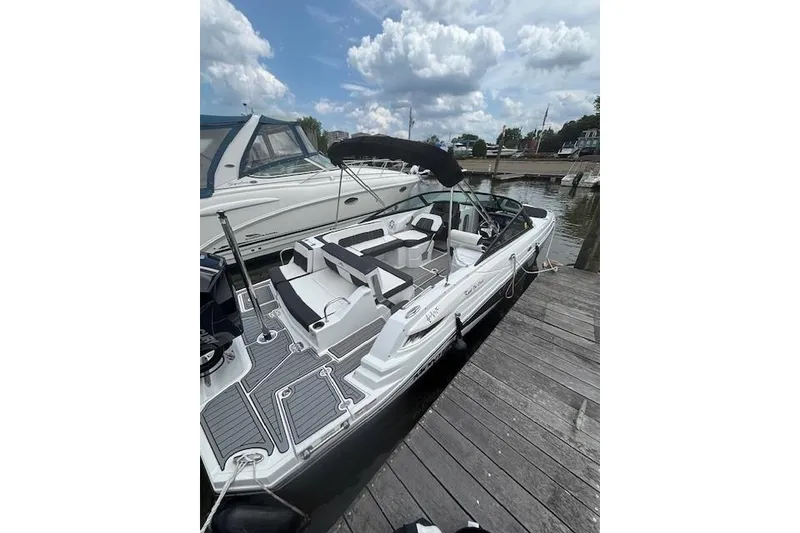The Image of 2023 Monterey M-45 boat docked, featuring sleek design and spacious seating under a cloudy sky. - 0