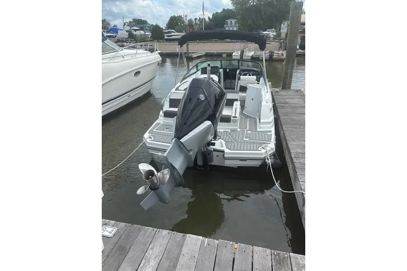 Slide: The Image of 2023 Monterey M-45 boat docked at marina, featuring sleek design and powerful outboard motor. - 1
