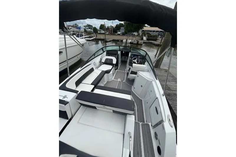 Slide: The Image of 2023 Monterey M-45 boat interior with sleek seating and modern design at a dock. - 2