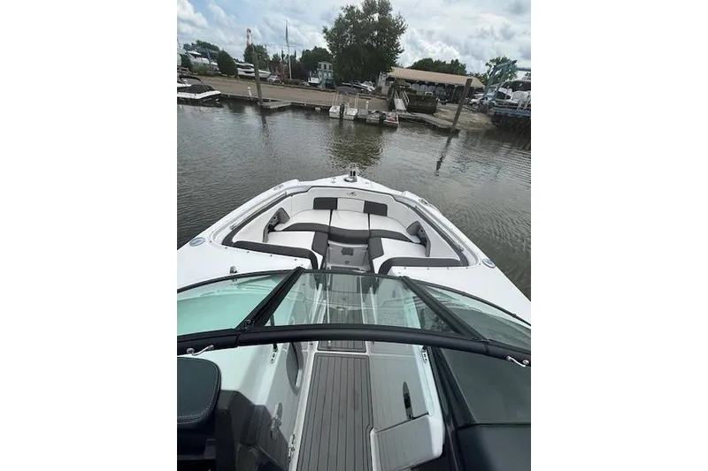 Slide: The Image of 2023 Monterey M-45 boat docked at a marina, featuring spacious seating and sleek design. - 5
