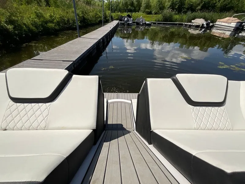 Slide: The Image of The image shows the stern of a 2025 Yamaha 222SD with sleek seating by the water. - 14