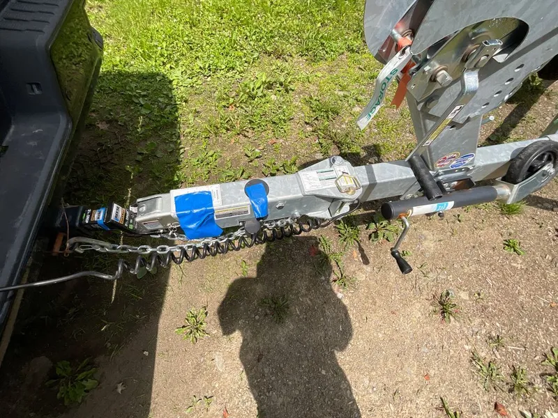 Slide: The Image of Close-up of a boat trailer hitch on a grassy surface. - 29