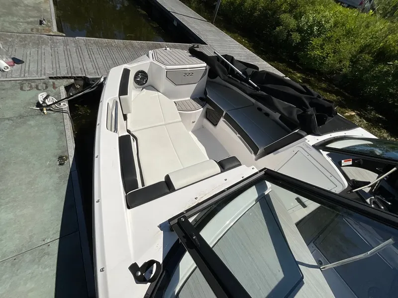 Slide: The Image of The image shows the cockpit of a 2025 Yamaha 222SD boat docked at a pier. - 5