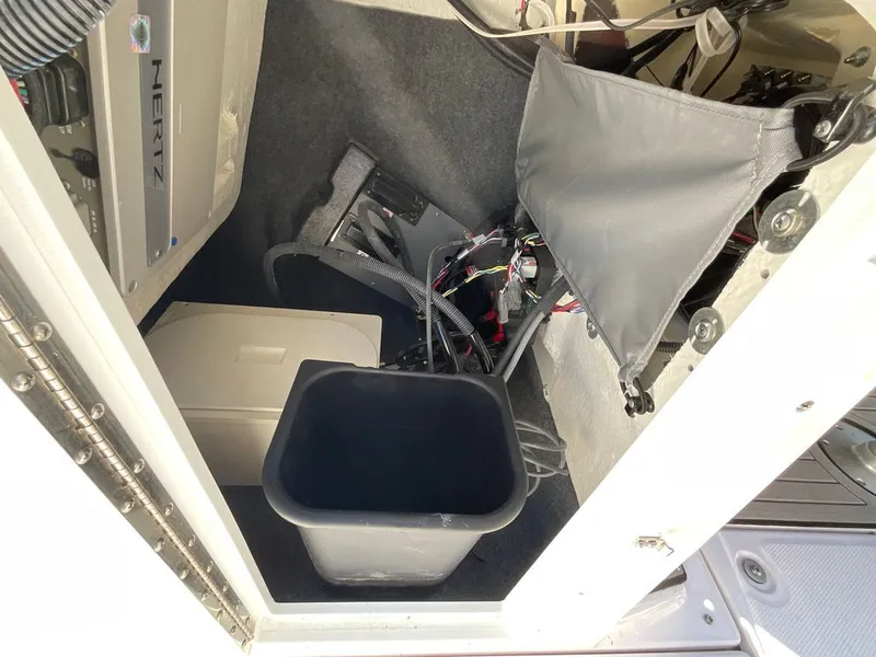 Slide: The Image of Interior of a Yamaha 222SD boat with cables and a black container. - 12