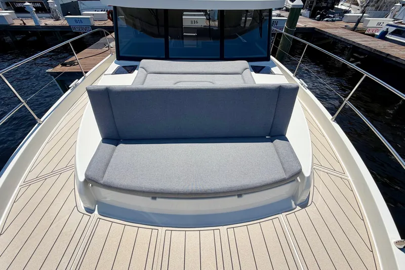 Slide: The Image of 2025 Beneteau Swift Trawler 41 Fly with spacious deck seating at the marina. - 14