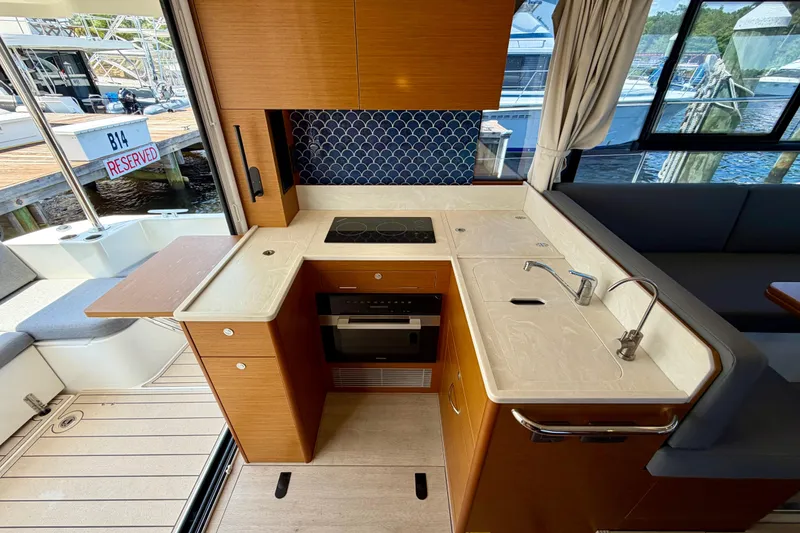 Slide: The Image of Modern kitchen in 2025 Beneteau Swift Trawler 41 Fly, featuring sleek countertops and appliances. - 19