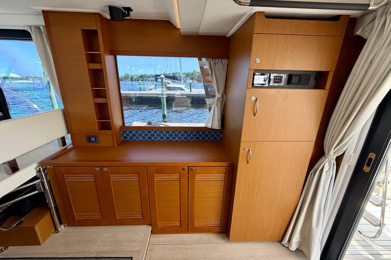 Slide: The Image of Interior of 2025 Beneteau Swift Trawler 41 Fly with wood cabinetry and window view. - 20