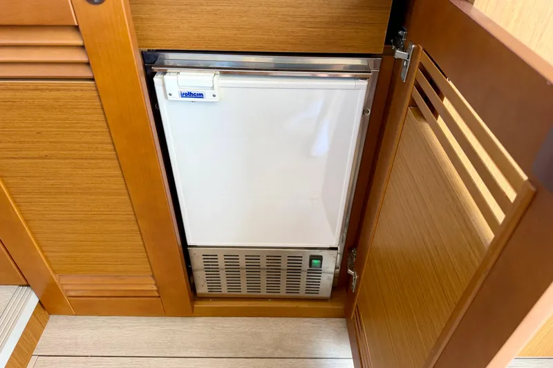 Slide: The Image of Built-in refrigerator on 2025 Beneteau Swift Trawler 41 Fly, wooden cabinetry. - 21