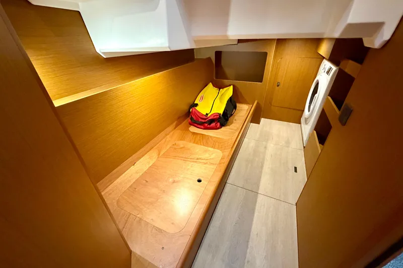 Slide: The Image of 2025 Beneteau Swift Trawler 41 Fly interior with wooden finish and laundry area. - 31