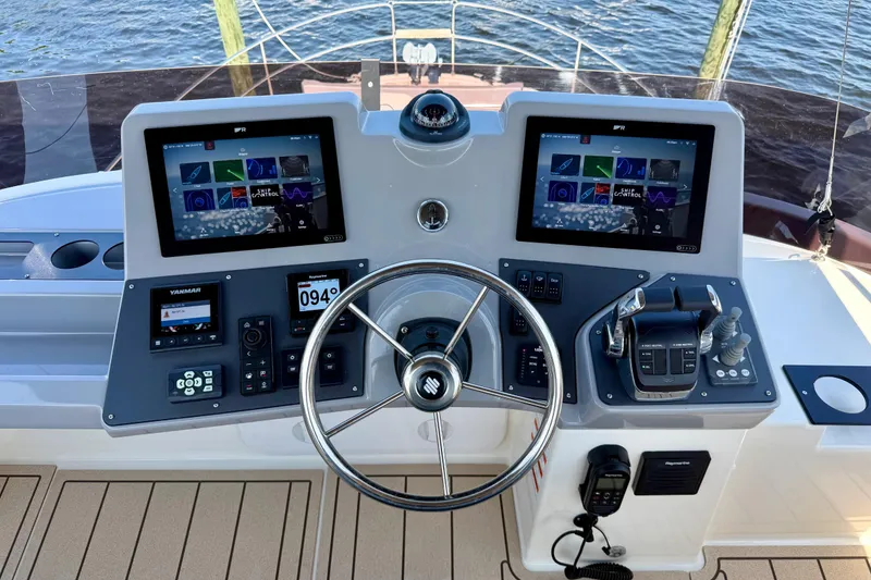 Slide: The Image of Helm of 2025 Beneteau Swift Trawler 41 Fly with dual screens and controls. - 10