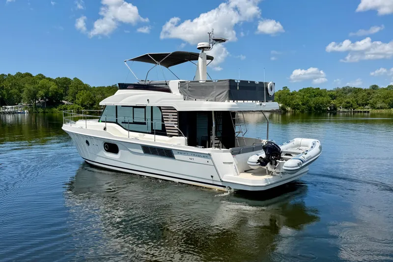 Slide: The Image of 2025 Beneteau Swift Trawler 41 Fly on serene lake under blue sky. - 7